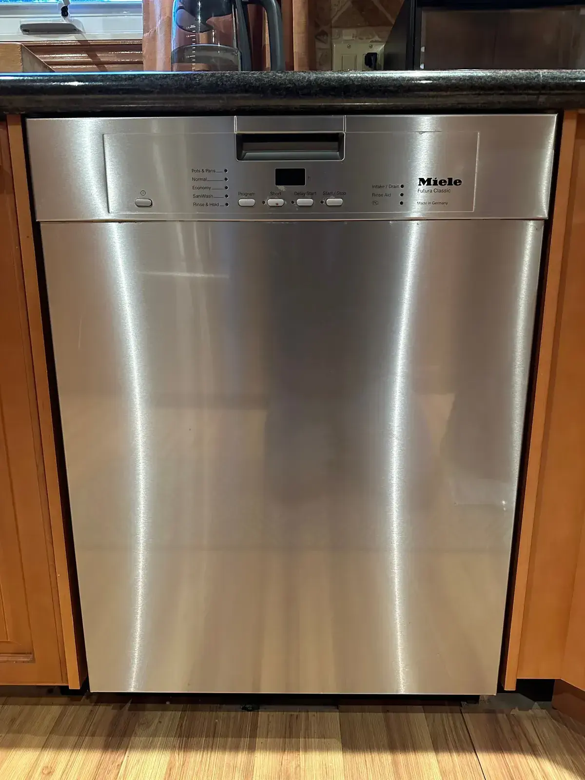 Miele dishwasher installed flush in wood cabinetry