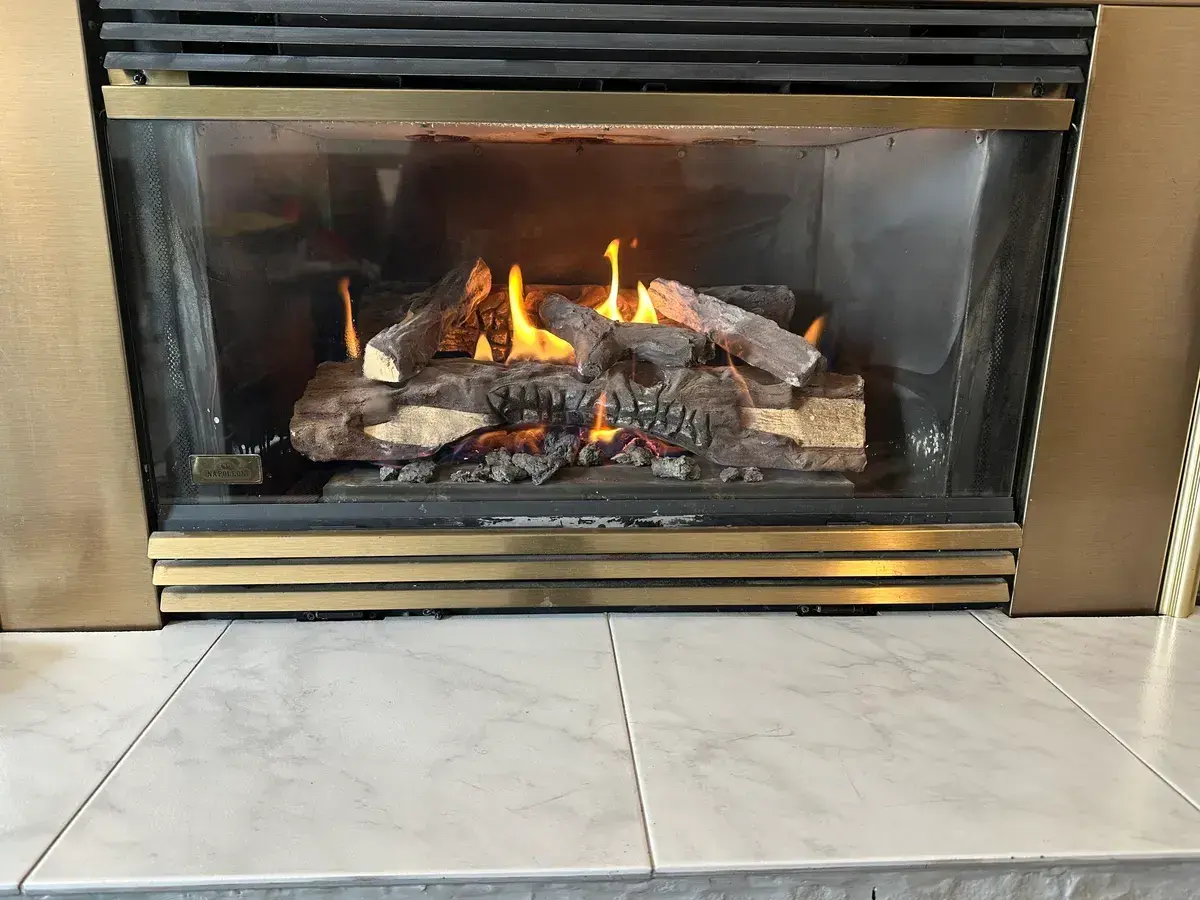 Close view of the lit log set inside a Napoleon gas fireplace insert