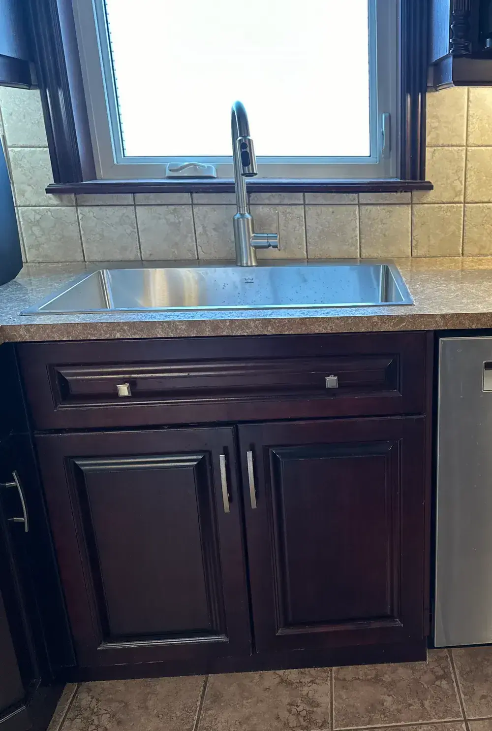 Finished stainless sink and faucet installation seen from above
