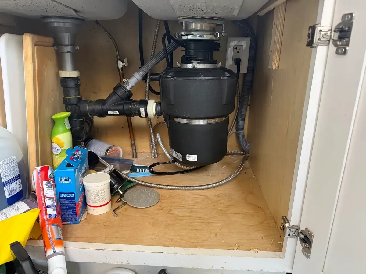 New pipework and shut-off valves fitted under a kitchen sink